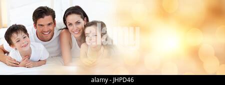 Digital composite of Family lying on floor smiling at camera wide shot Banque D'Images