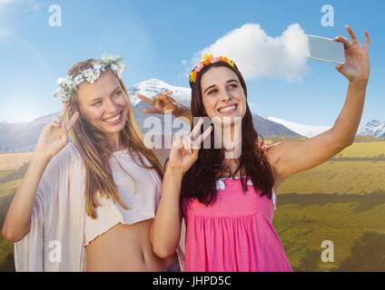 Composite numérique des femmes prenant selfies occasionnels photo devant un paysage de montagne Banque D'Images