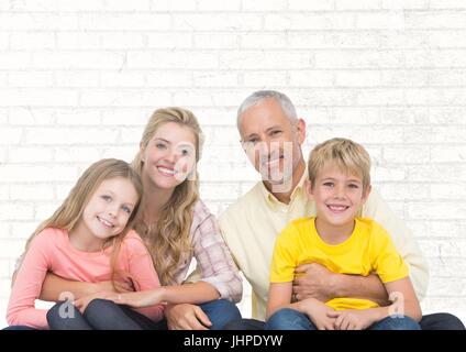 Digital composite of Family sitting in front of bright wall background Banque D'Images