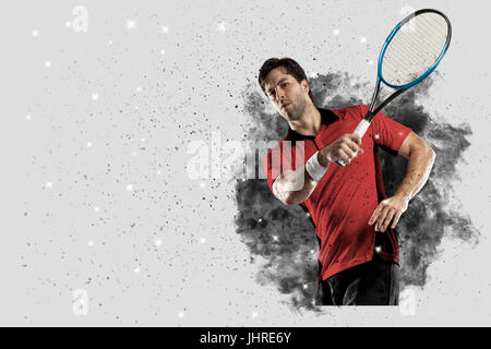 Joueur de tennis avec un uniforme rouge qui sort d'une explosion de fumée . Banque D'Images