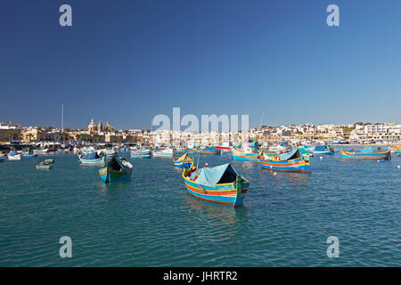 Vue urbaine avec bateaux de pêche colorés, Luzzus, Marsaxlokk, Malte Banque D'Images