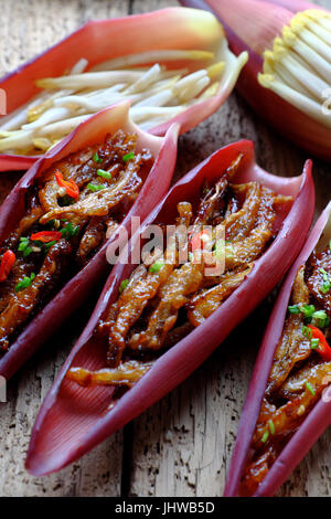 La transformation des aliments végétariens de fleur de bananier, rouler les jeunes fruits banane avec la farine puis fry et recouvrir de sauce de soja, le sucre et le piment, nourriture vegan Banque D'Images