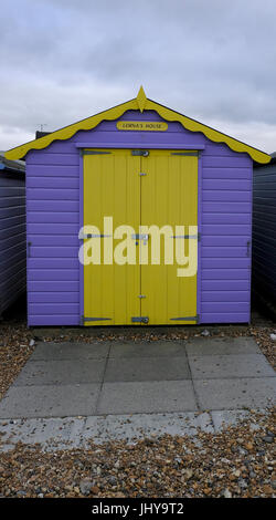 Peint en jaune et violet beach hut sur Ferring beach près de Worthing, West Sussex, UK. Banque D'Images