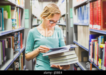 Fille étudiant dans la bibliothèque à lire des livres, de l'éducation concept Banque D'Images