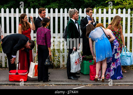 Les jeunes amateurs d'opéra avec leurs paniers pique-nique arrivent à la gare de Lewes, en route vers l'opéra de Glyndebourne, Lewes, dans le Sussex, UK Banque D'Images