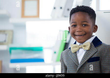 Close up portrait of boy in suit at office Banque D'Images