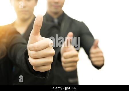 La réussite de l'entreprise concept Selective focus on Thumbs up de business man sur fond blanc. Ton chaleureux avec flare effet de lumière. Banque D'Images
