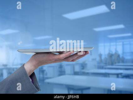 Digital composite of Businesswoman holding tablet en usine atelier bleu Banque D'Images