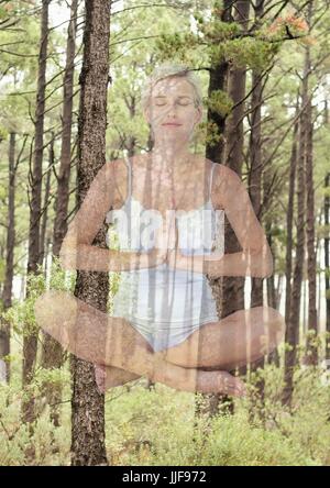 Digital composite of woman doing yoga en face de bois Banque D'Images