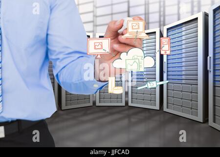 Digital composite of business man holding des dessins en salle serveur Banque D'Images