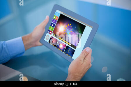 Portrait sa tablette contre composite image de diverses icônes vidéo et informatiques Banque D'Images