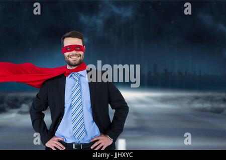 Portrait of smiling businesswoman wearing superhero costume Banque D'Images
