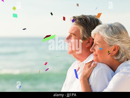 Confetti contre vieux couple looking out to sea Banque D'Images