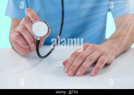 Image 3D composite de midsection of surgeon holding stethoscope Banque D'Images