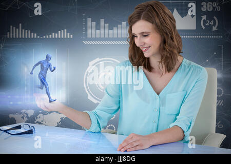 3d composite image of businesswoman sitting at desk et l'aide de l'écran numérique Banque D'Images