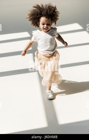 Cute african american baby girl in white studio Banque D'Images