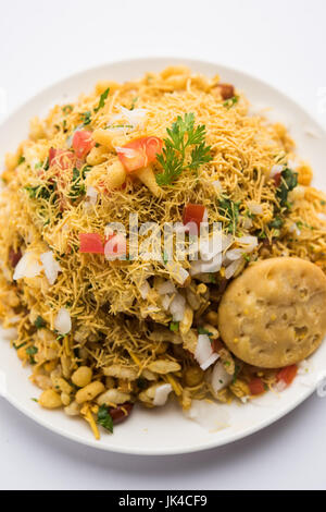 Bhel Puri - Mumbai populaires street servi avec de la coriandre et du chutney de tamarin sur fond blanc, selective focus Banque D'Images