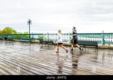La ville de Québec, Canada - 30 mai 2017 : deux personnes en couple, homme et femme, s'exécutant sur la terrasse Dufferin humide au cours de jour de pluie par le Château Frontenac Château Banque D'Images
