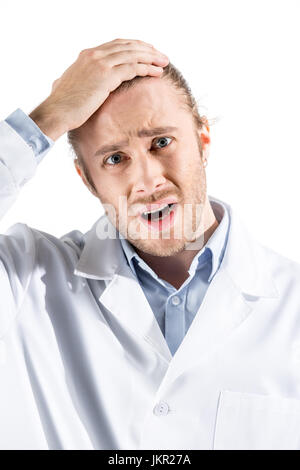 Portrait of young doctor in white coat looking at camera isolated on white Banque D'Images