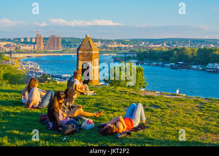 Les gens relazing sur l'herbe en été, le parc de Kalemegdan, avec une vue vers la rivière Sava, Belgrade, Serbie Banque D'Images