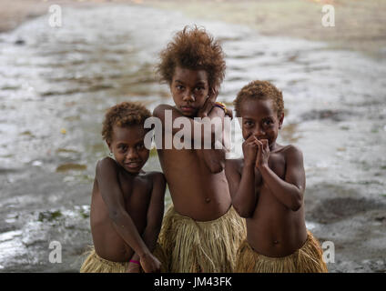 Trois jeunes filles dans l'herbe traditionnelle de jupes, de l'île de Tanna, Vanuatu, Yakel Banque D'Images