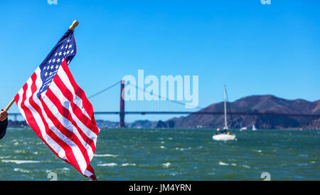 SAN FRANCISCO-LE 25 SEPTEMBRE : drapeau américain avec le Golden Gate Bridge en arrière-plan le jour de USA's victoire historique de l'America's Cup title Banque D'Images