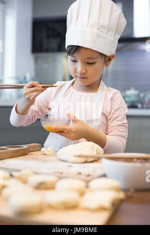 Happy little girl baking chinois à la maison Banque D'Images