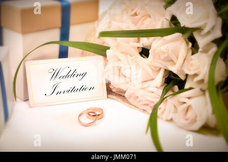 Carte d'Invitation de mariage avec des anneaux, des cadeaux et des roses Banque D'Images