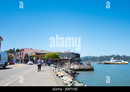 Un ferry de San Francisco est visible, ainsi que les entreprises du centre-ville, sur Bridgeway Road dans la région de la baie de San Francisco, ville de Sausalito, Californie, le 29 juin 2017. Banque D'Images