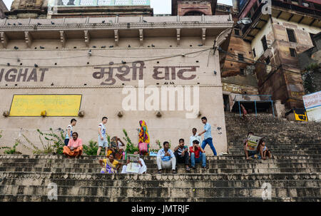 Varanasi, Inde - Jul 12, 2015. Des gens assis sur les rives du Gange au lever du soleil à Varanasi, Inde. Varanasi attire pèlerins hindous qui se baignent dans le Gange Banque D'Images