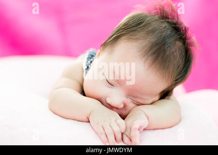 Portrait d'un adorable petit infant baby girl le bâillement avant de dormir sur le lit à l'intérieur Banque D'Images