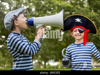 Digital composite de Boy pointing et pirate en face d'arbres Banque D'Images