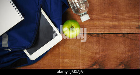 Cartable avec apple et tablette numérique sur table en bois Banque D'Images