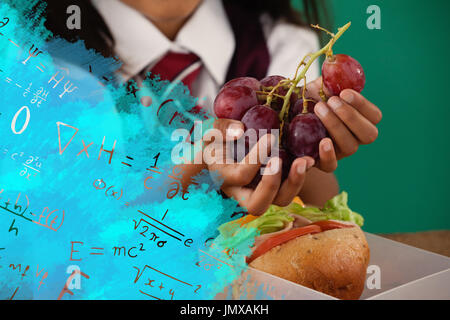 Image composite numérique des formules algébriques contre lycéenne ayant fruits raisin Banque D'Images