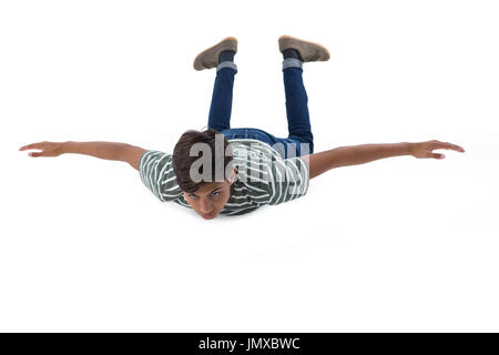 Teenage boy lying on the floor against white background Banque D'Images