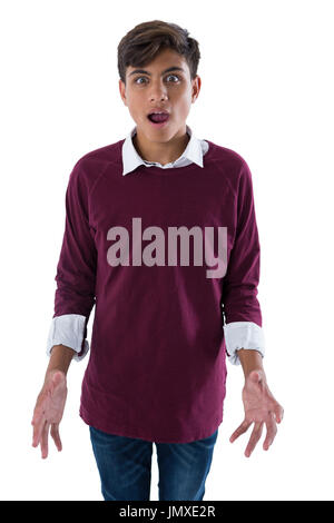 Portrait of teenage boy standing against white background Banque D'Images