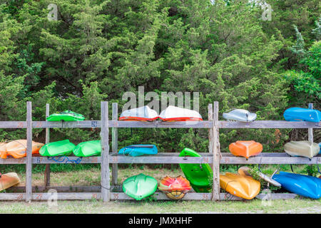 De couleur différentes sur un rack en bois des kayaks à l'eau claire dans la plage d'East Hampton, ny Banque D'Images