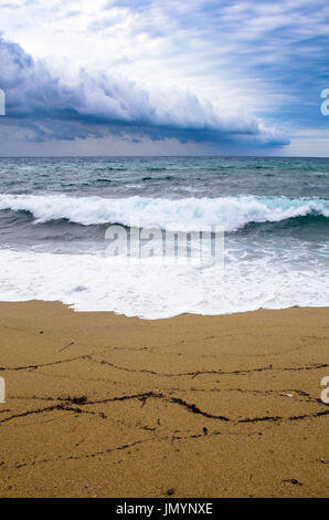 Vue sur la plage un jour de tempête, la mer est fortement déplacé, et le ciel chargé de nuages menaçants et noir Banque D'Images