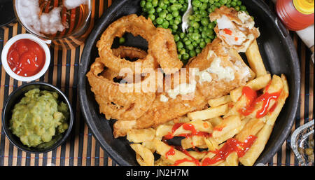 De haut en bas vue de l'anglais fish and chips avec petits pois, oignons et petits pois anneau Banque D'Images