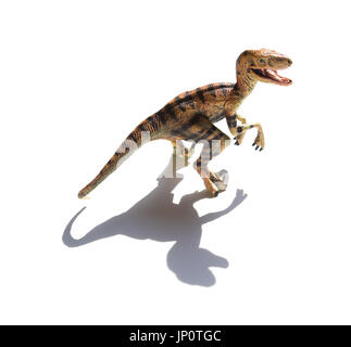 Velociraptor jaune jouet sur un fond blanc avec ombre Banque D'Images