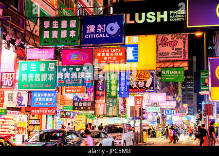 HONG KONG, le 10 juillet 2017 : néons panneaux colorés accrocher précairement sur édifices le long de Nathan Road à Mongkok, l'un des plus achalandé et le plus popul Banque D'Images