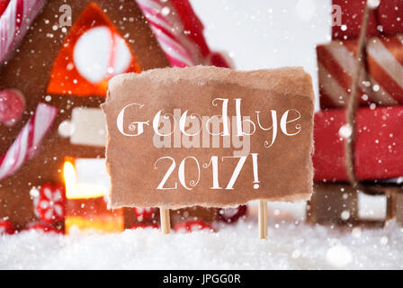 Gingerbread House dans un paysage enneigé comme décoration de Noël. Sleigh avec cadeaux de Noël ou des cadeaux et des flocons de neige. L'étiquette avec un texte anglais Au revoir 20 Banque D'Images