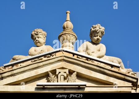 Les sculptures d'angel garçons sur façade du bâtiment d'architecture au centre-ville de Bakou. Banque D'Images