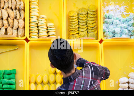 Vue de dessus d'un jeune vendeur au food vente de gâteaux et de Malaisie sweet à Kota Kinabalu, Sabah, Bornéo, Malaisie. Banque D'Images