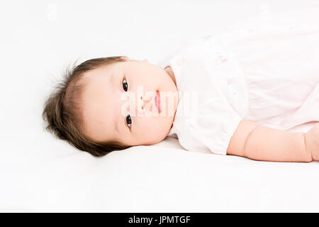 Portrait d'un adorable petit bébé fille bébé allongé sur le dos sur la couverture Banque D'Images