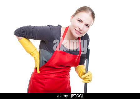 Jeune femme de ménage ayant mal au dos après avoir nettoyé et lavé le plancher sur fond blanc Banque D'Images