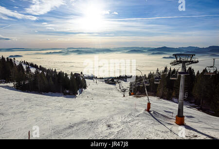 Zone de ski près de la capitale slovène. C'est le plus souvent les sports d'hiver. Le salon donne sur la vallée avec le brouillard qui enveloppait la ville au coucher du soleil Banque D'Images