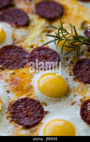 Oeufs de caille frit avec de la saucisse en noir pan Banque D'Images