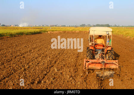 HAI Duong, Vietnam, septembre, 29 : rouge tracteur sur le terrain travaillant sur des terres, 29 septembre, 2014 à Hai Duong, Vietnam. Banque D'Images