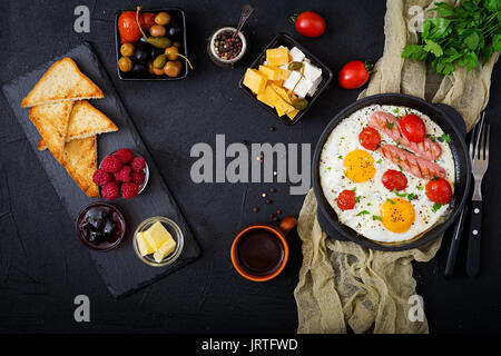 Petit-déjeuner anglais - œuf frit, tomates et saucisses. Vue d'en haut. Mise à plat Banque D'Images